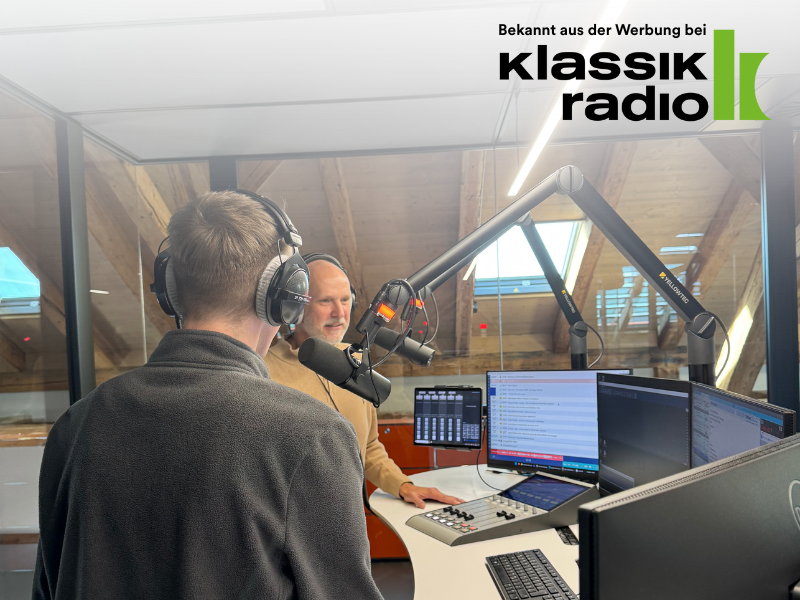 Zwei Personen sprechen mit Headsets und Mikrofonen in einem Radiostudio bei Klassik Radio