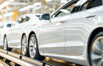 Fahrzeuge auf einem Montageband in einer Automobilfabri, symbolisch für moderne Produktionsprozesse und Catena-X